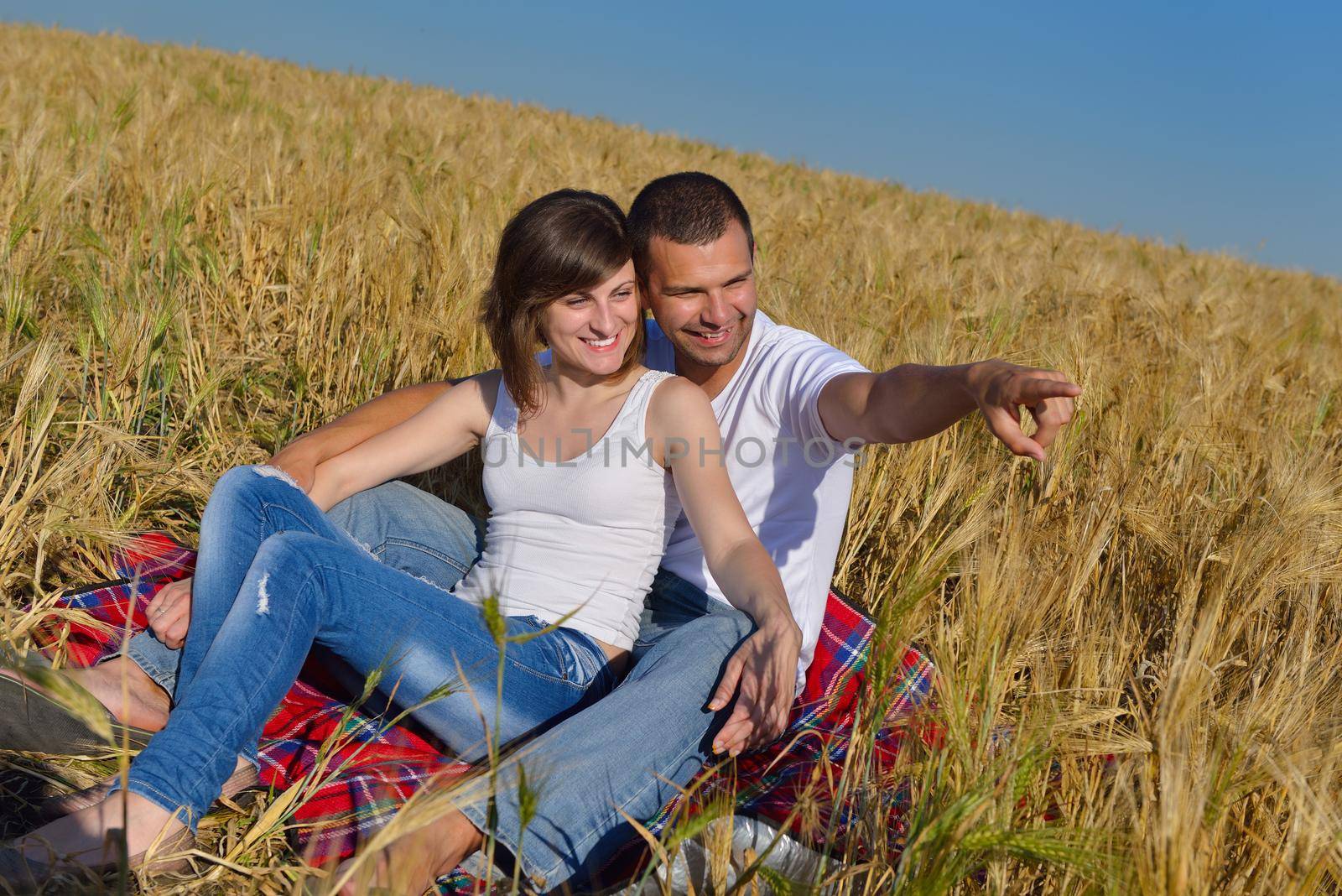 happy young couple in love have romance and fun at wheat field in summer