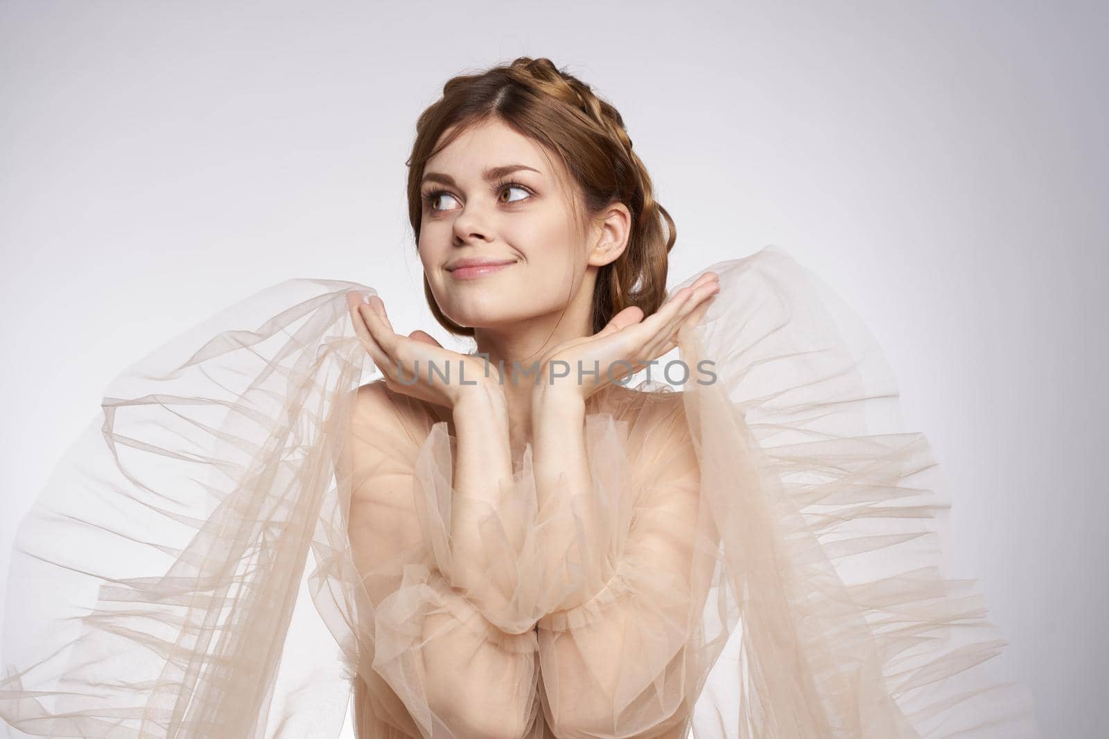 pretty woman gesture hands cosmetics fashion hairstyle posing light background. High quality photo