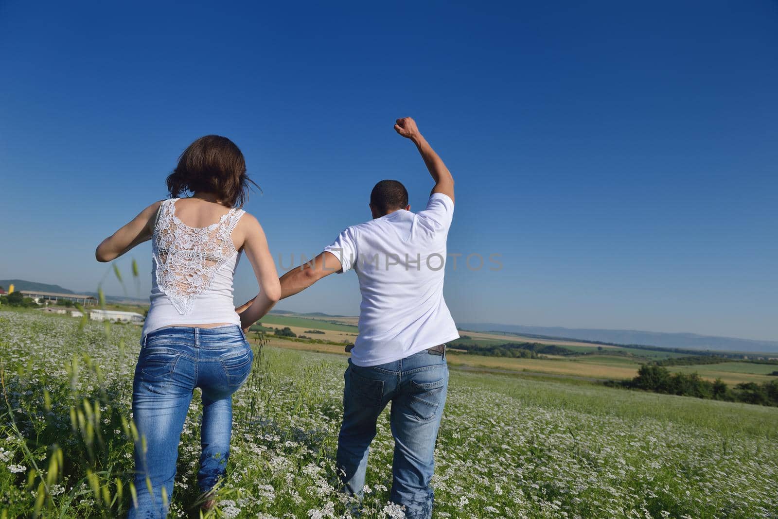 happy young couple in love have romance and fun at wheat field in summer