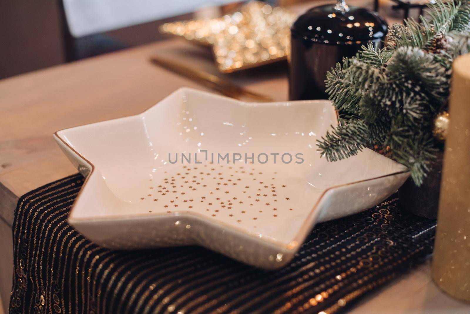 Serving table with festive dishes and candles. New Year eve concept