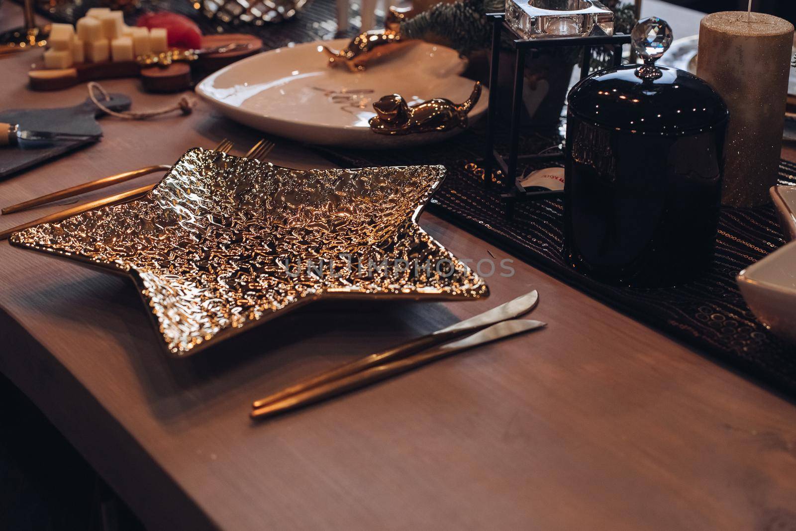 Golden star-shaped plate on New Year table. New Year eve concept