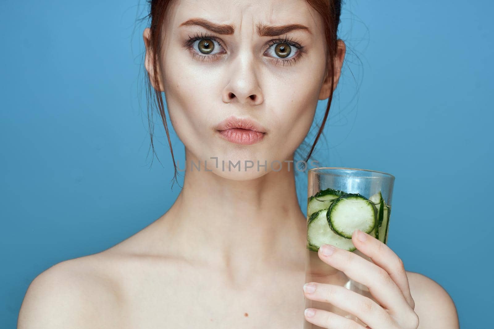pretty woman with cucumber drink health vitamins. High quality photo