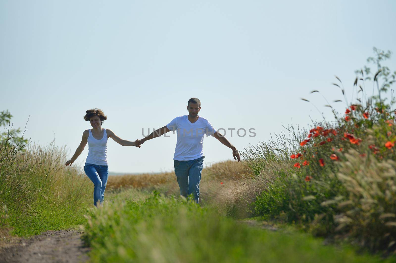 happy young couple in love have romance and fun at wheat field in summer