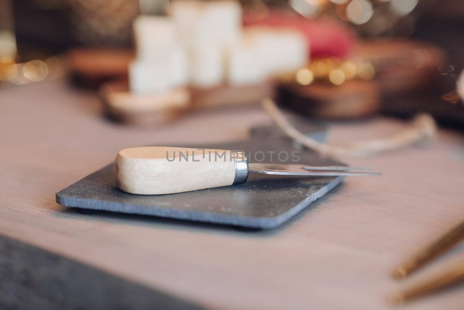 Close up of cheese fork on the festive table by StudioLucky