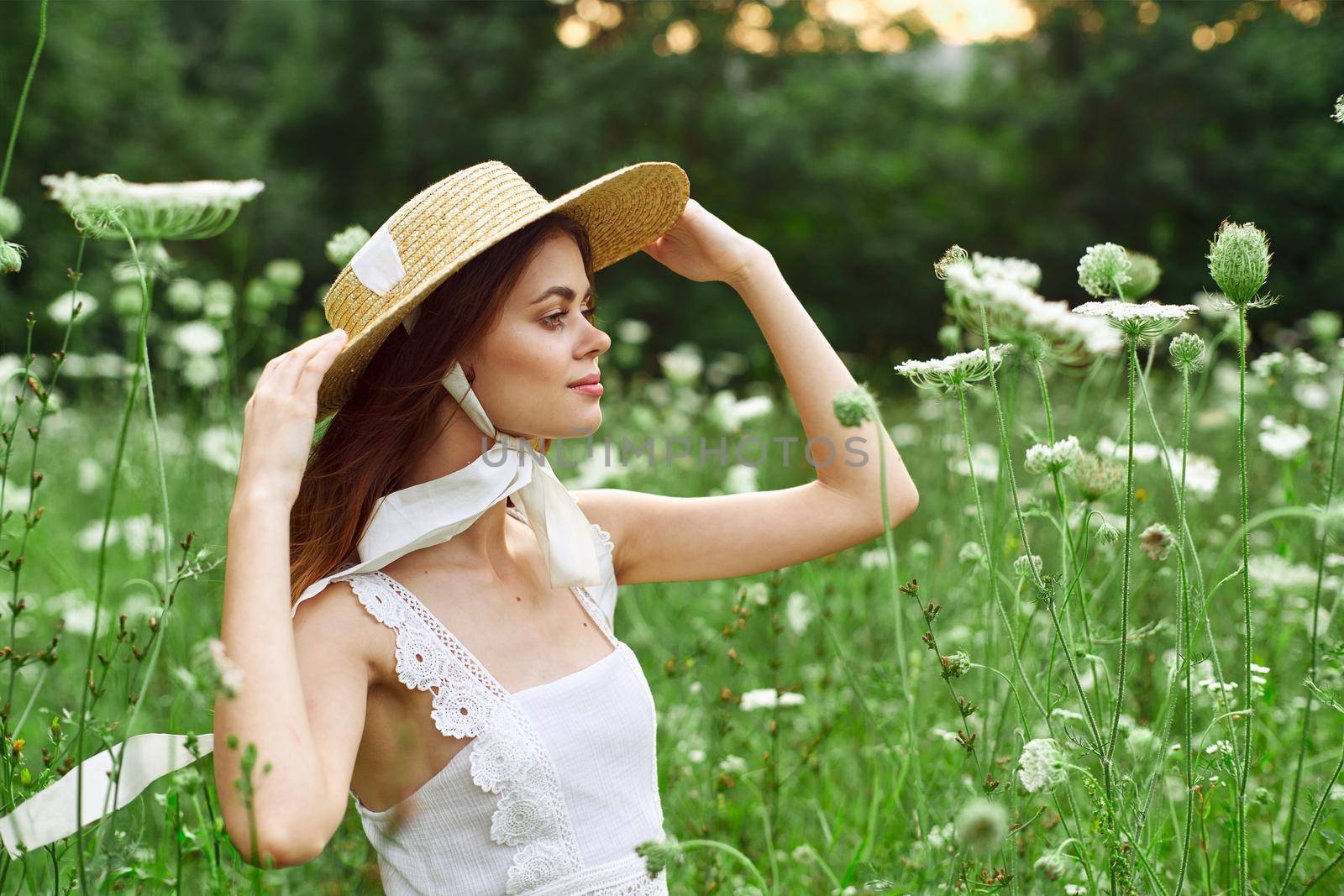 Woman with hat white dress flowers nature relaxation. High quality photo