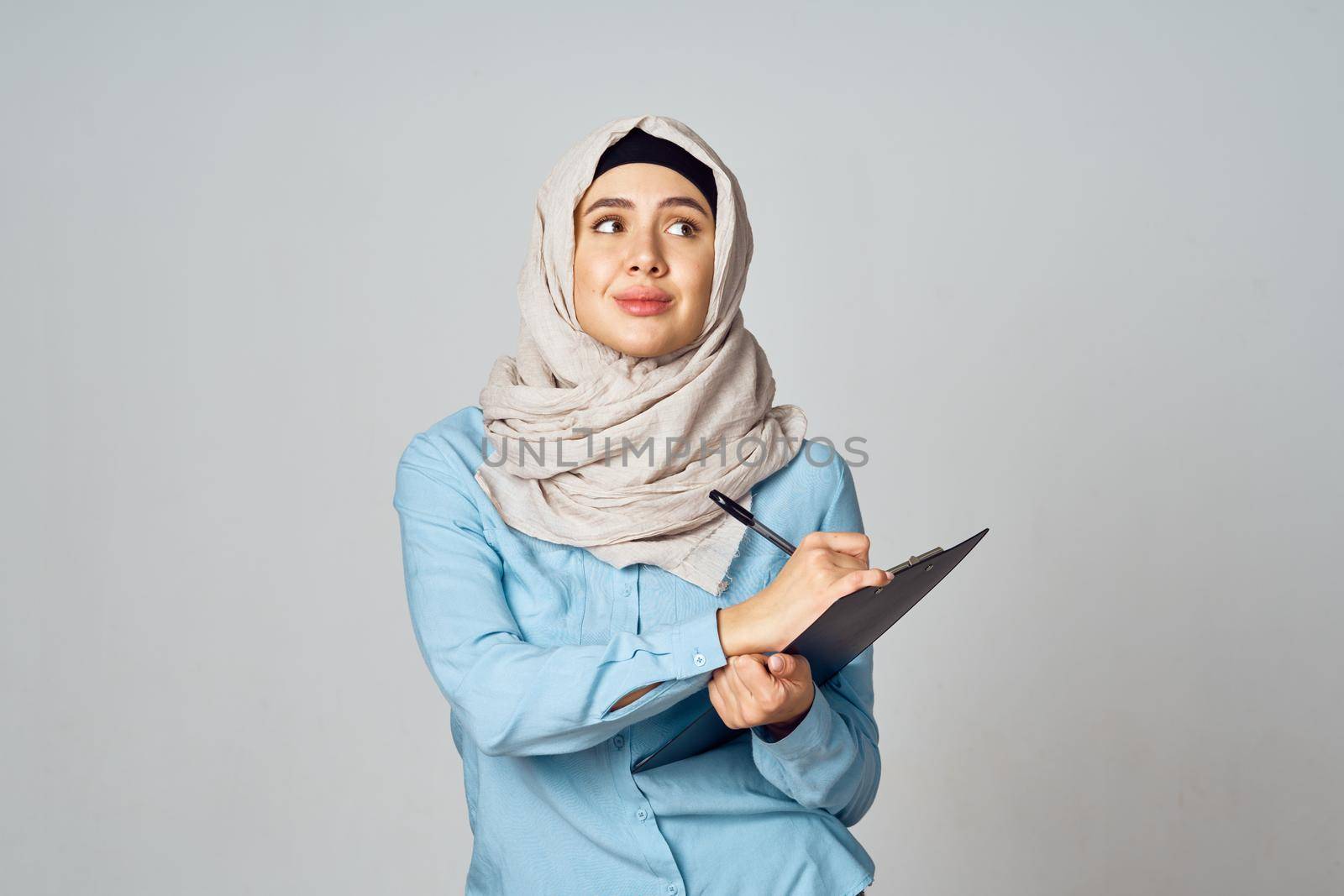 Muslim woman in hijab documents office work. High quality photo