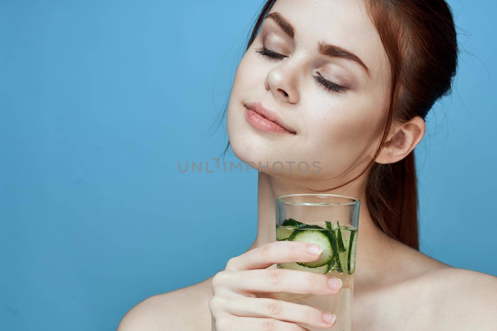 pretty woman with cucumber drink health vitamins. High quality photo