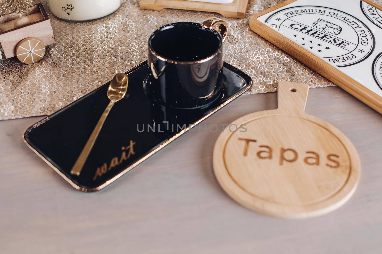 Black coffee mug on table decorated with New Year decor. New Year eve concept