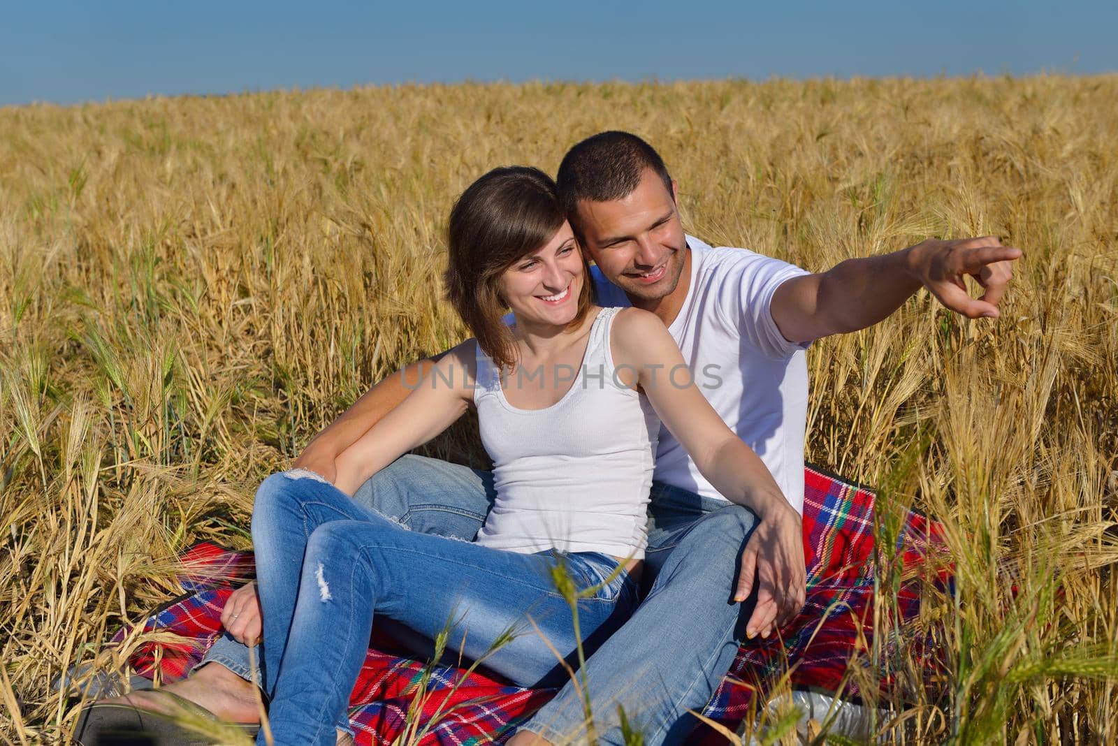 happy young couple in love have romance and fun at wheat field in summer