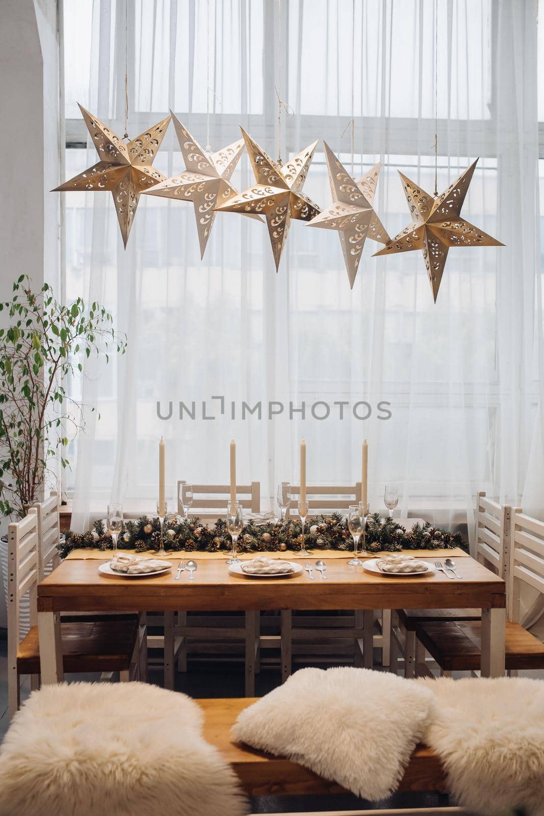 Dining table with decorative fir branches. Christmas holidays by StudioLucky