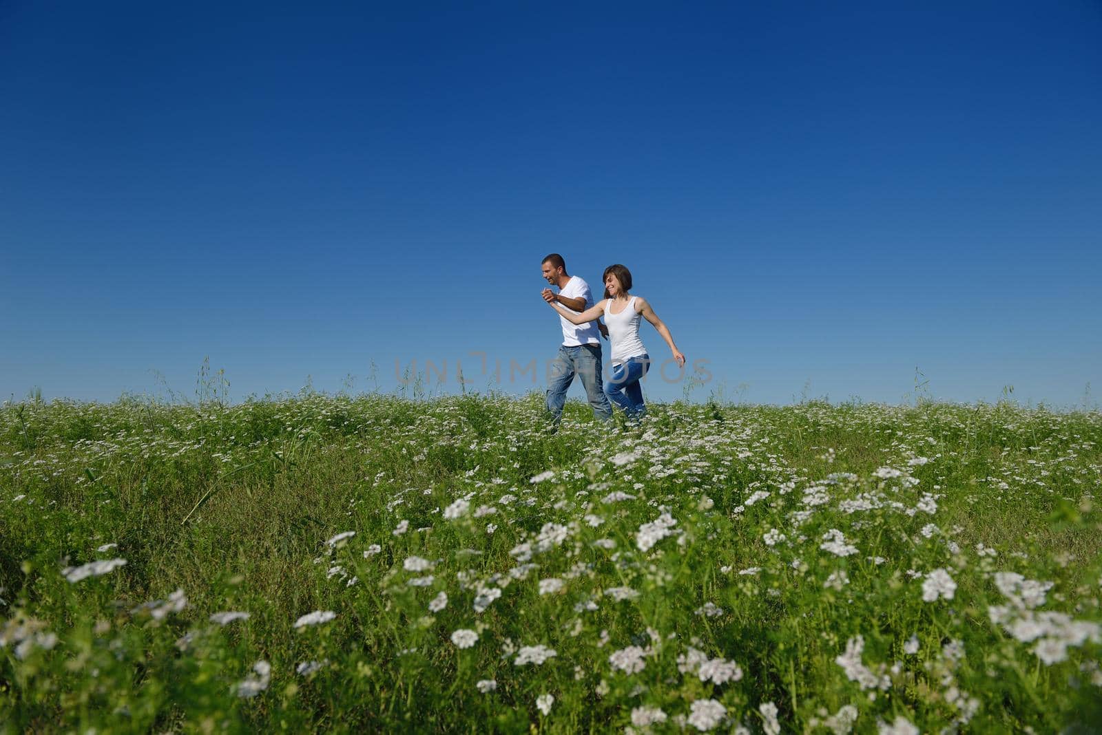 happy young couple in love have romance and fun at wheat field in summer