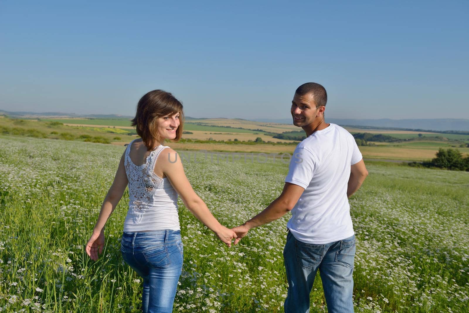 happy young couple in love have romance and fun at wheat field in summer