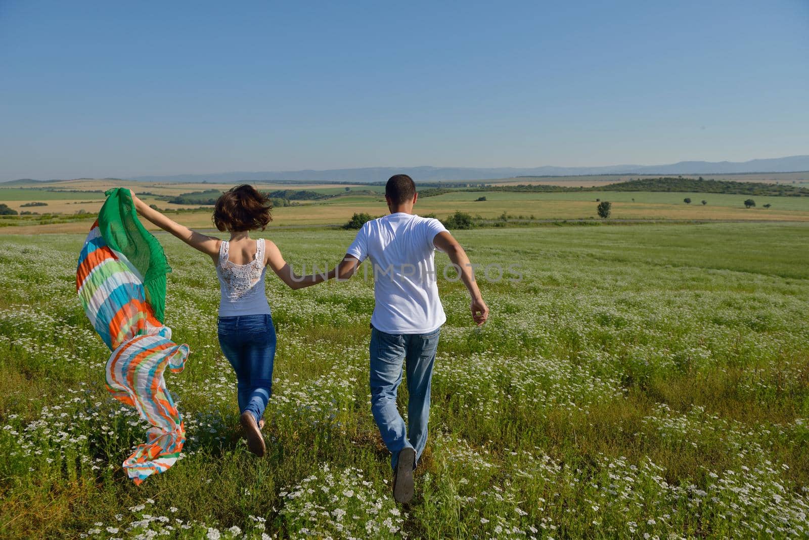 happy young couple in love have romance and fun at wheat field in summer