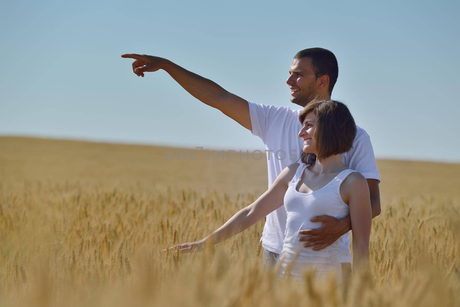 happy young couple in love have romance and fun at wheat field in summer