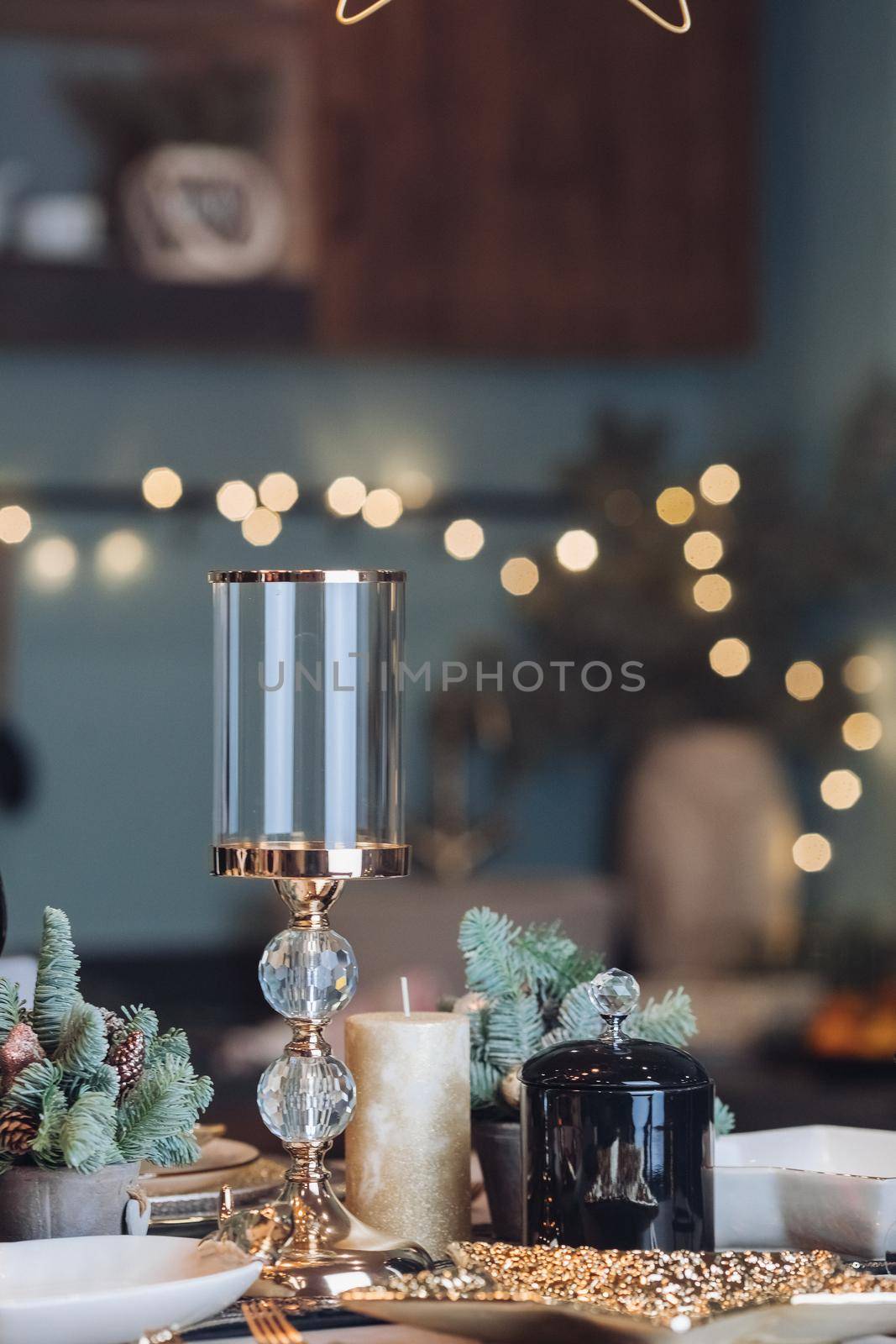 Glass candlestick on a New Year table by StudioLucky