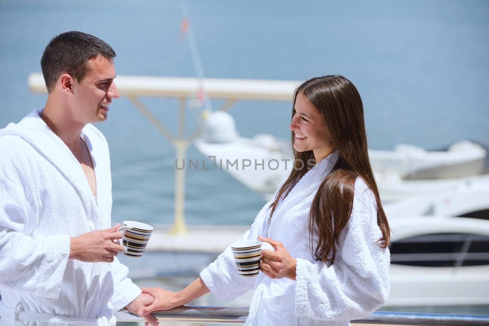 Romantic young couple spending time together and relaxing on yacht