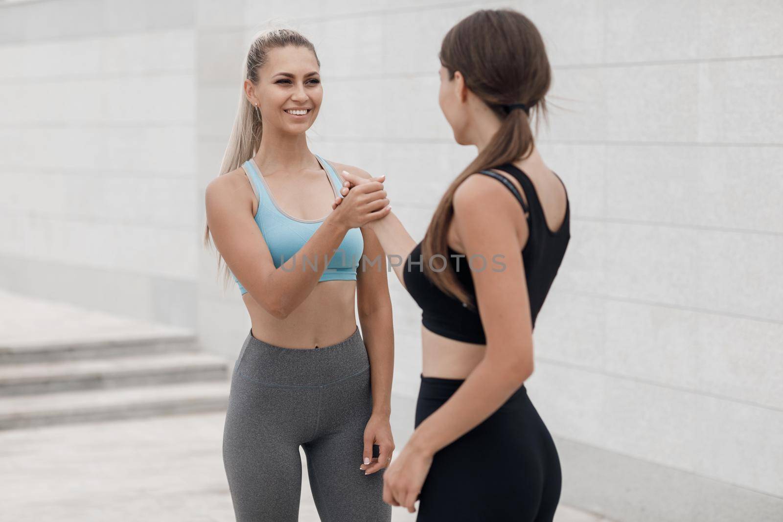 Two women doing fitness outdoor. High quality photo