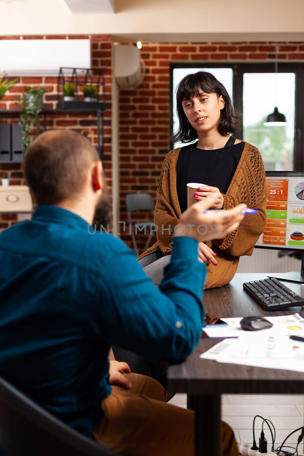 Executive manager talking with entrepreneur woman discussing marketing strategy working at company presentation brainstorming ideas in startup office. Businesspeople planning business meeting