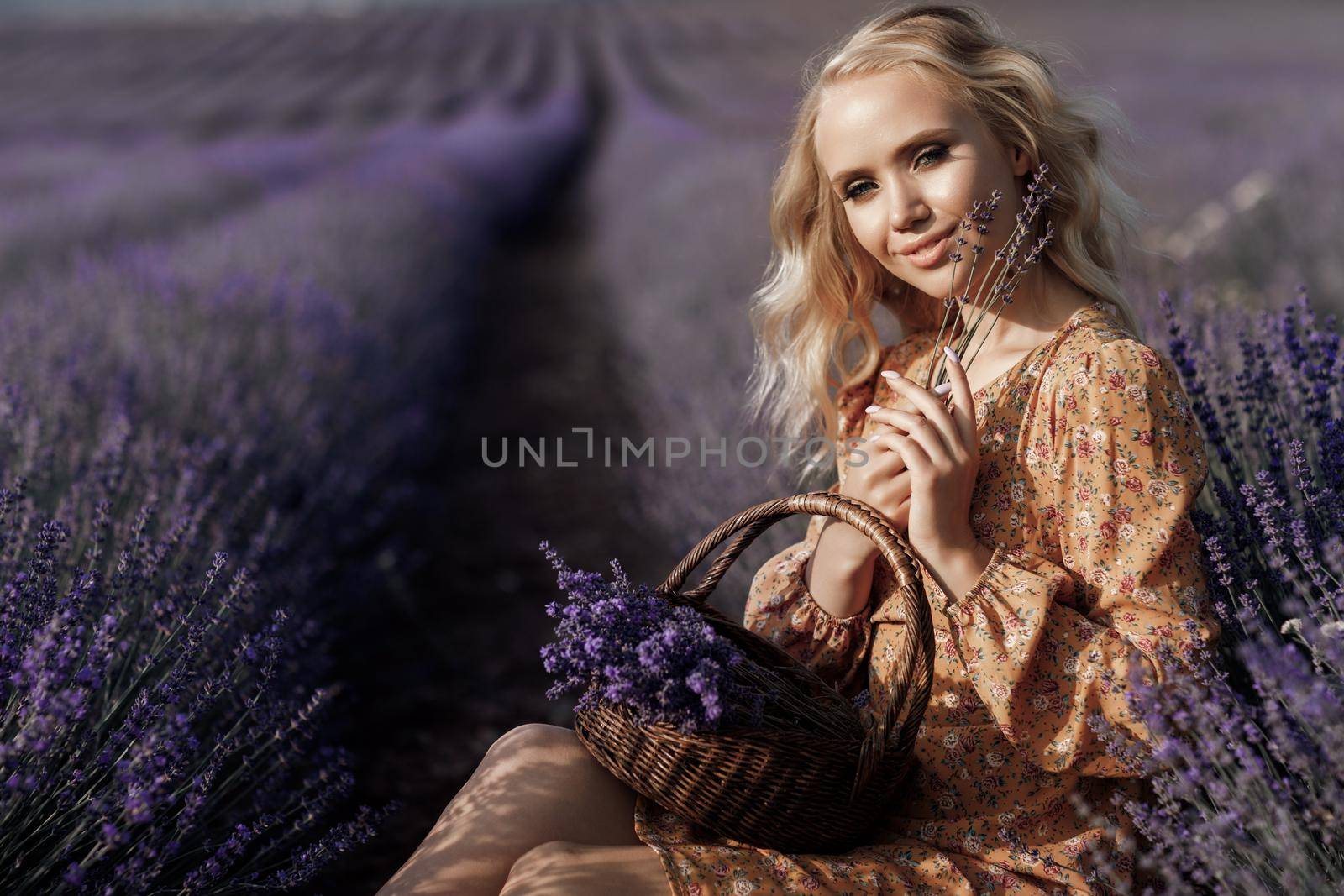 Fashion portrait of a pretty young woman in lavender field. High quality photo