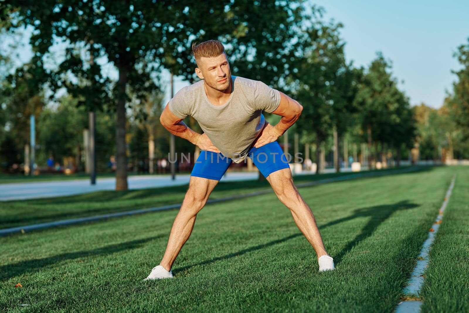 sporty man in the park on the lawn exercise lifestyle. High quality photo