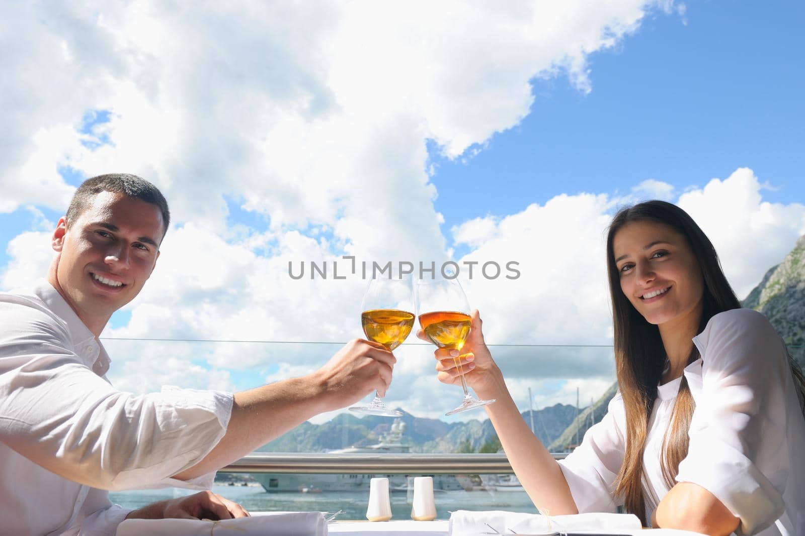 happy young couple having lanch at beautiful restaurant on the beach