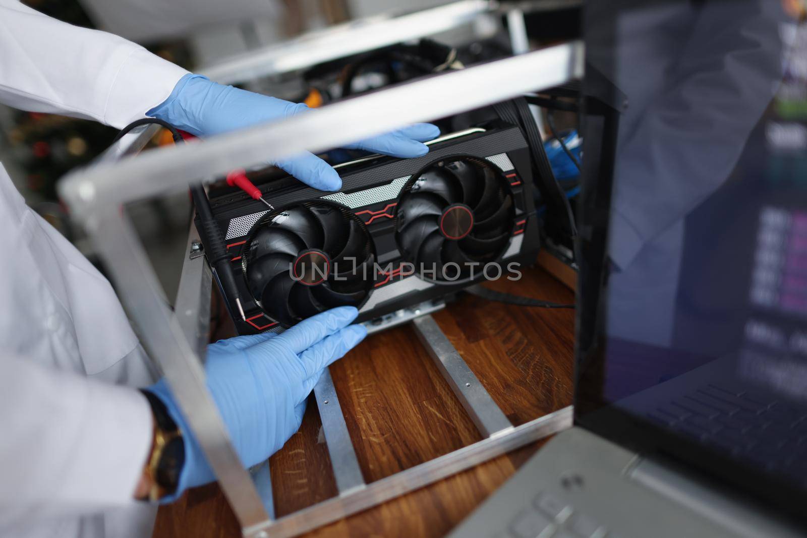 Man mechanic installing cooler fan with copper tubes on computer processor by kuprevich