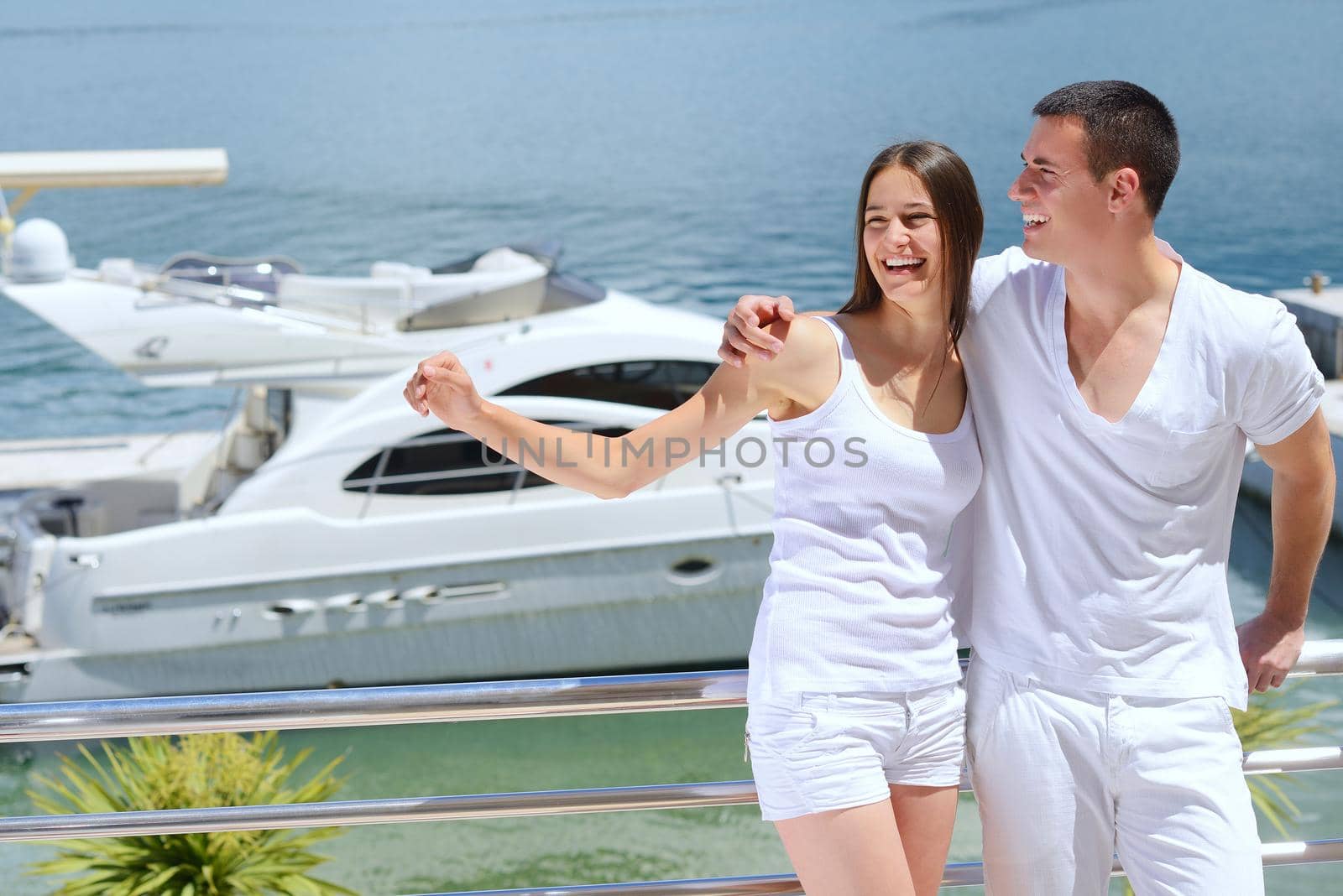 Romantic young couple spending time together and relaxing on yacht