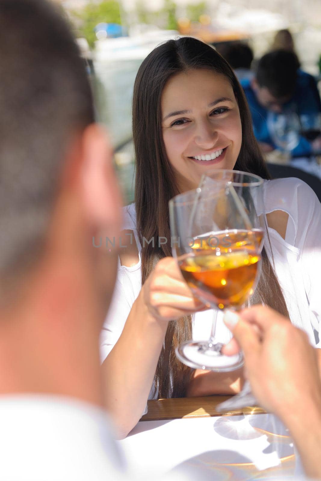 happy young couple having lanch at beautiful restaurant on the beach