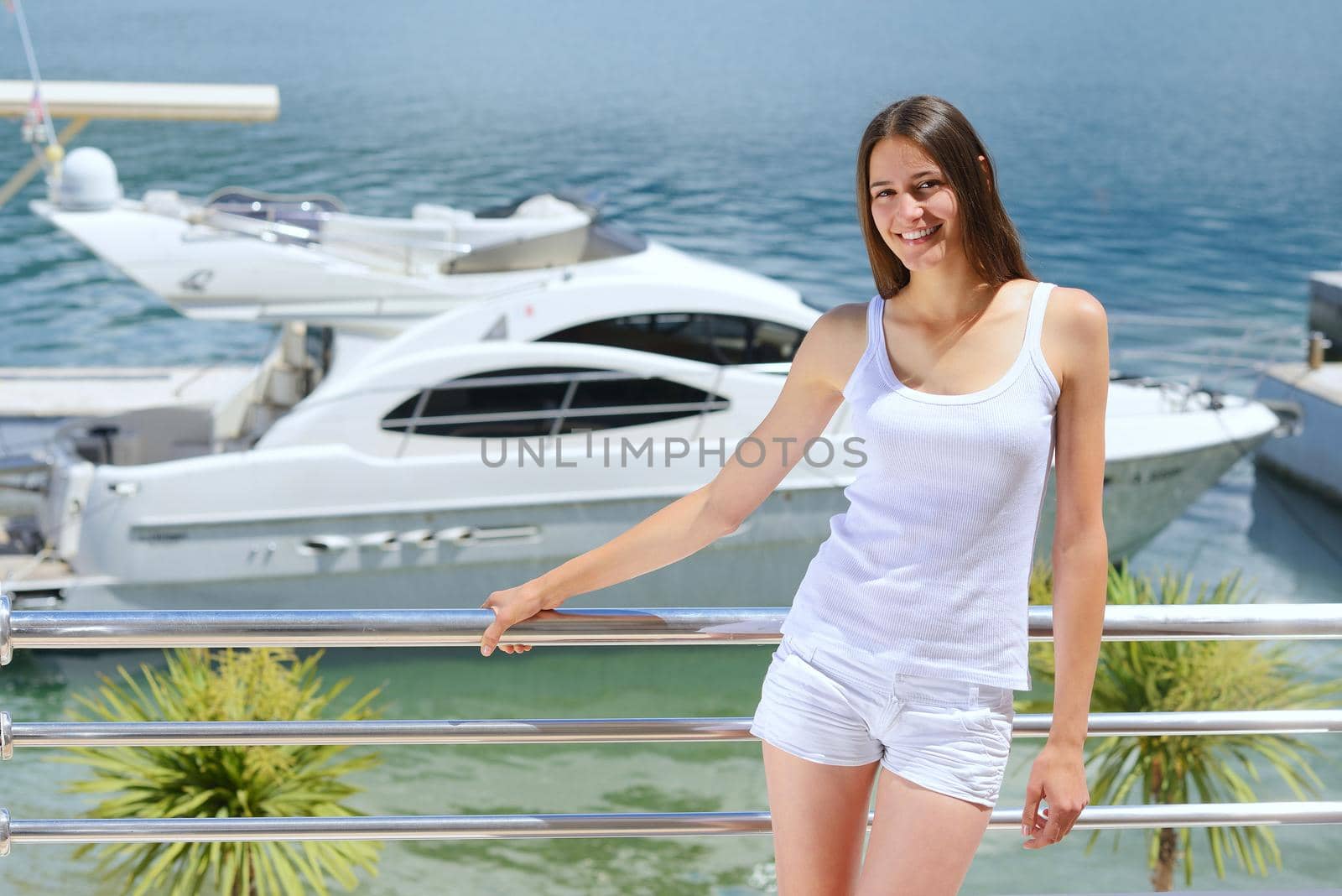 woman lies on a luxury yacht in the sea and looking to the horizon