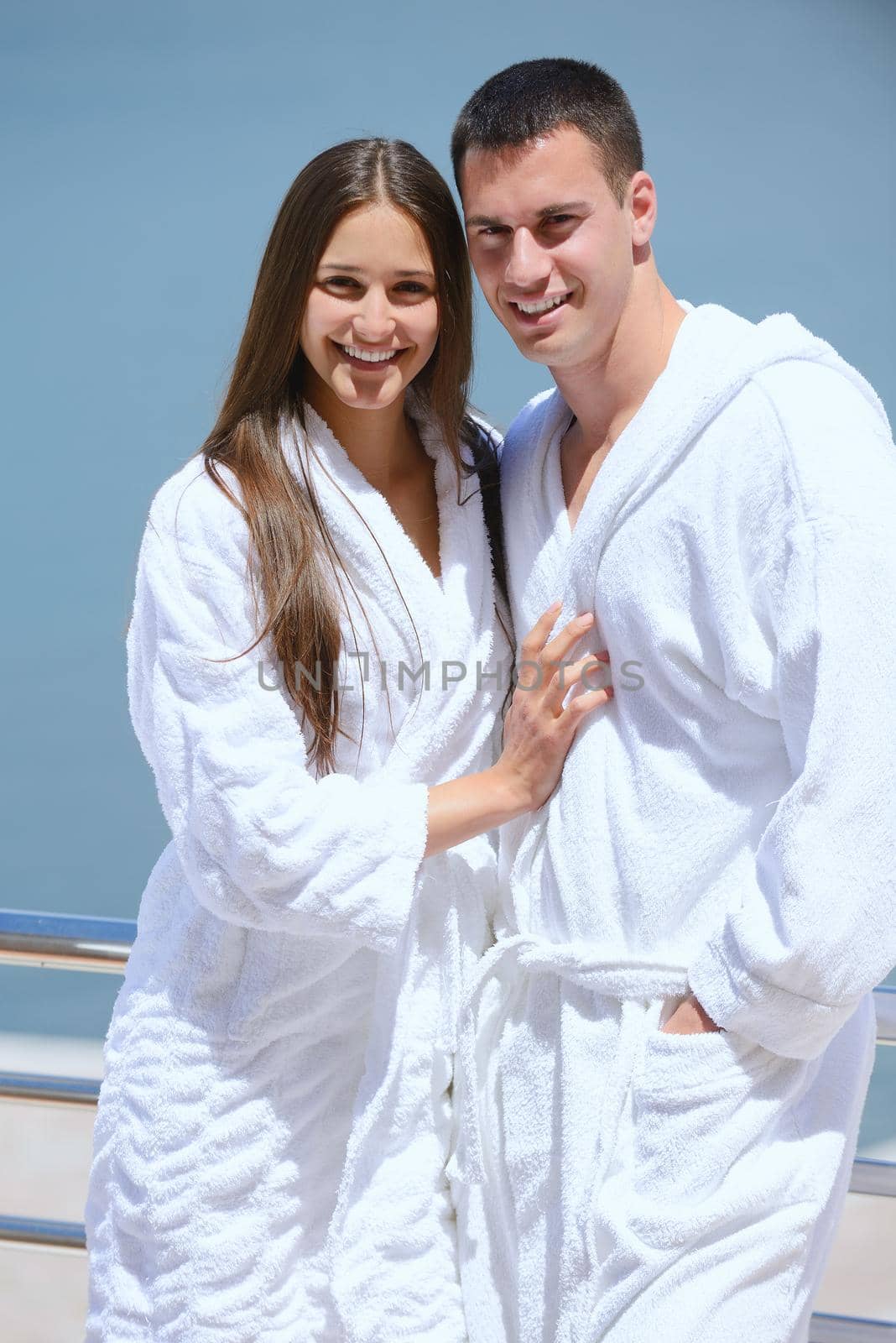 Romantic young couple spending time together and relaxing on yacht