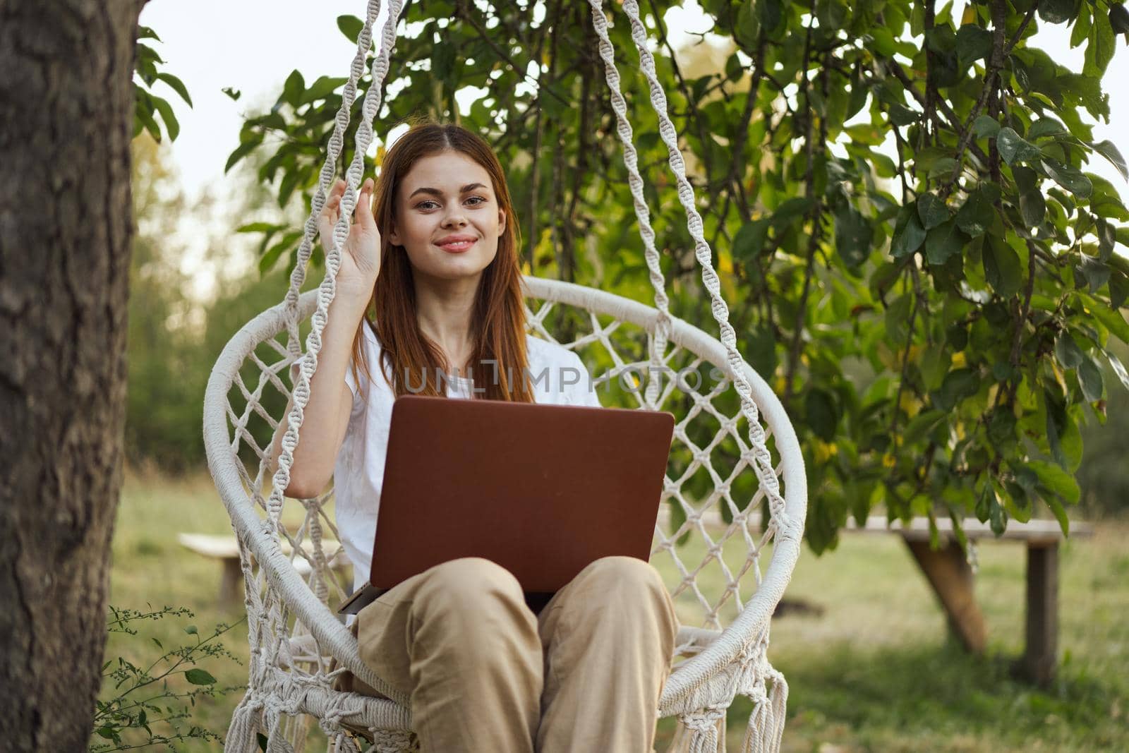 woman with laptop outdoors resting in hammock internet by Vichizh
