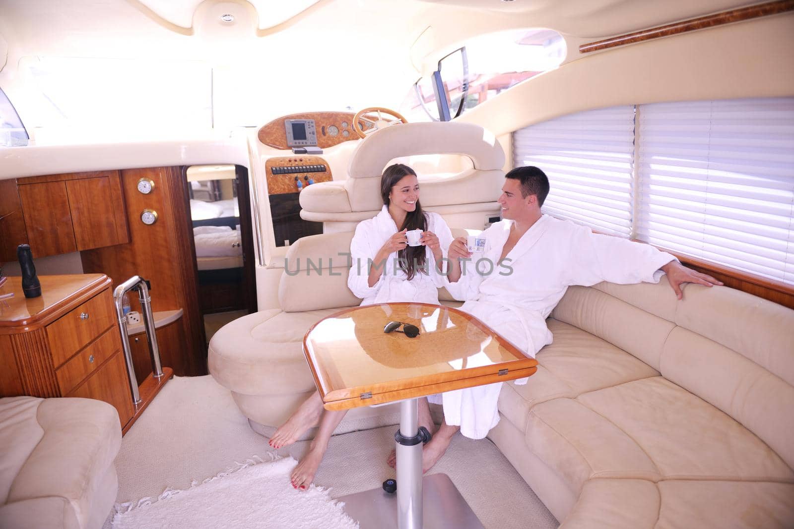 Romantic young couple spending time together and relaxing on yacht