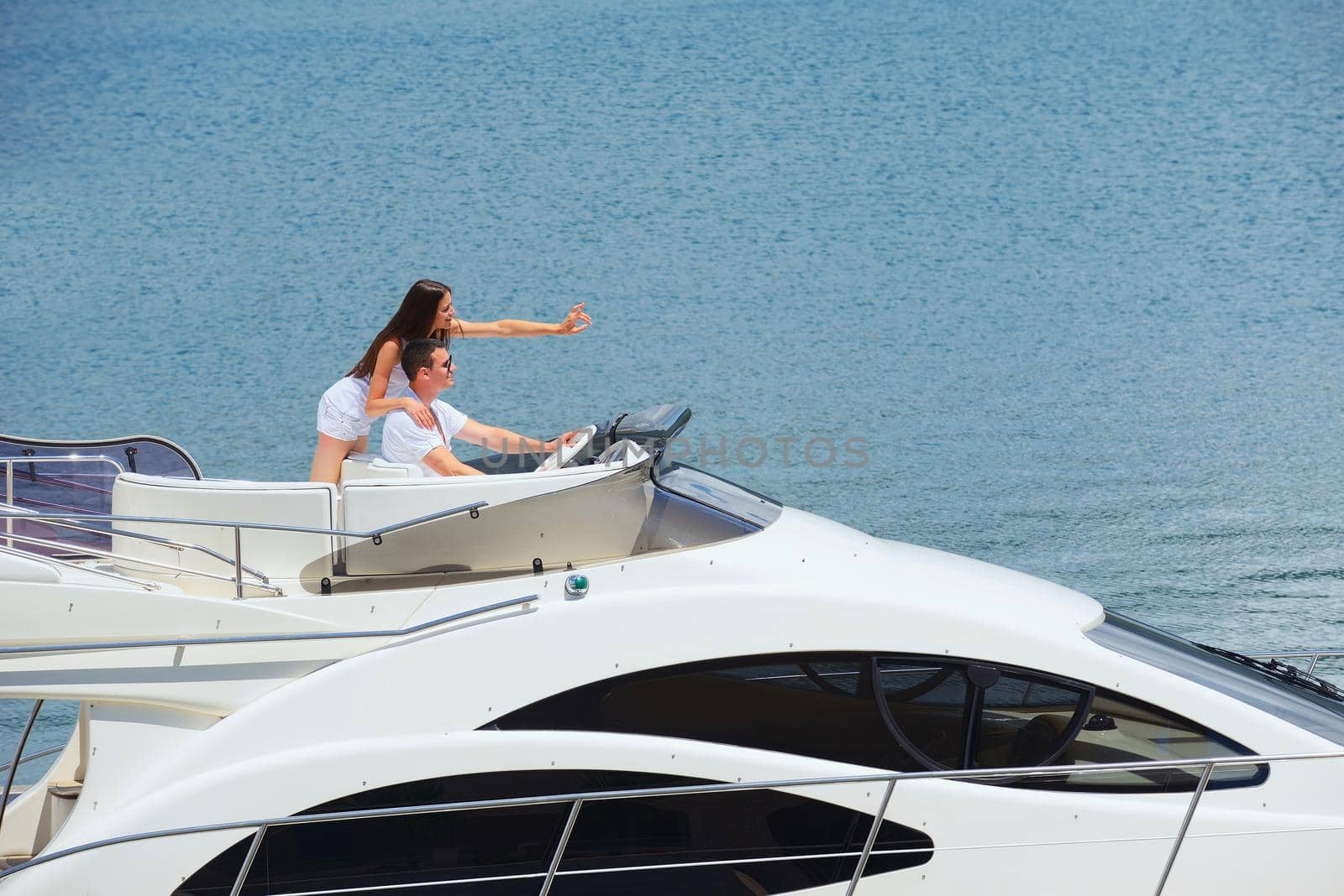 Romantic young couple spending time together and relaxing on yacht