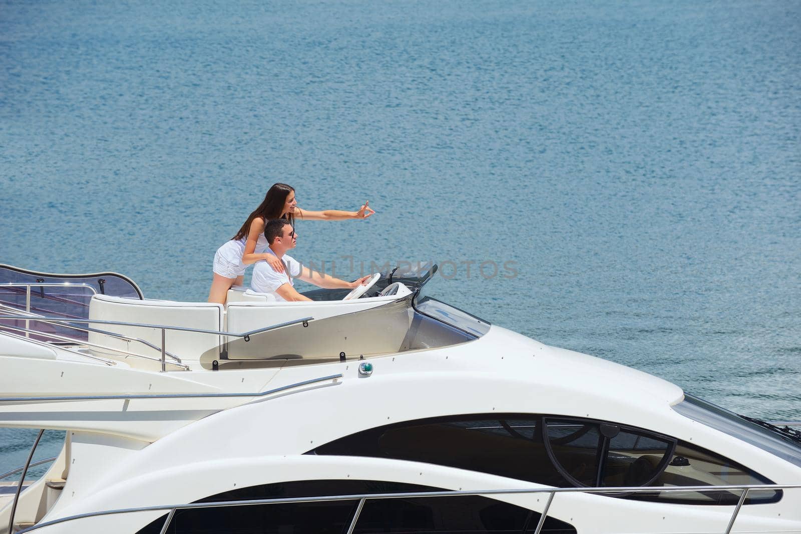 Romantic young couple spending time together and relaxing on yacht