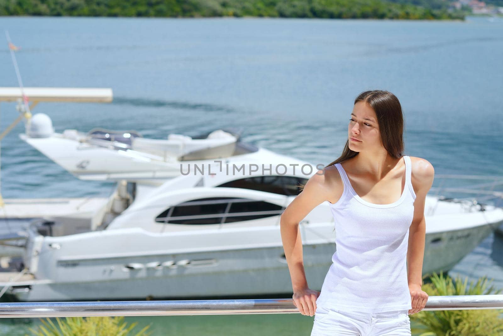 woman lies on a luxury yacht in the sea and looking to the horizon