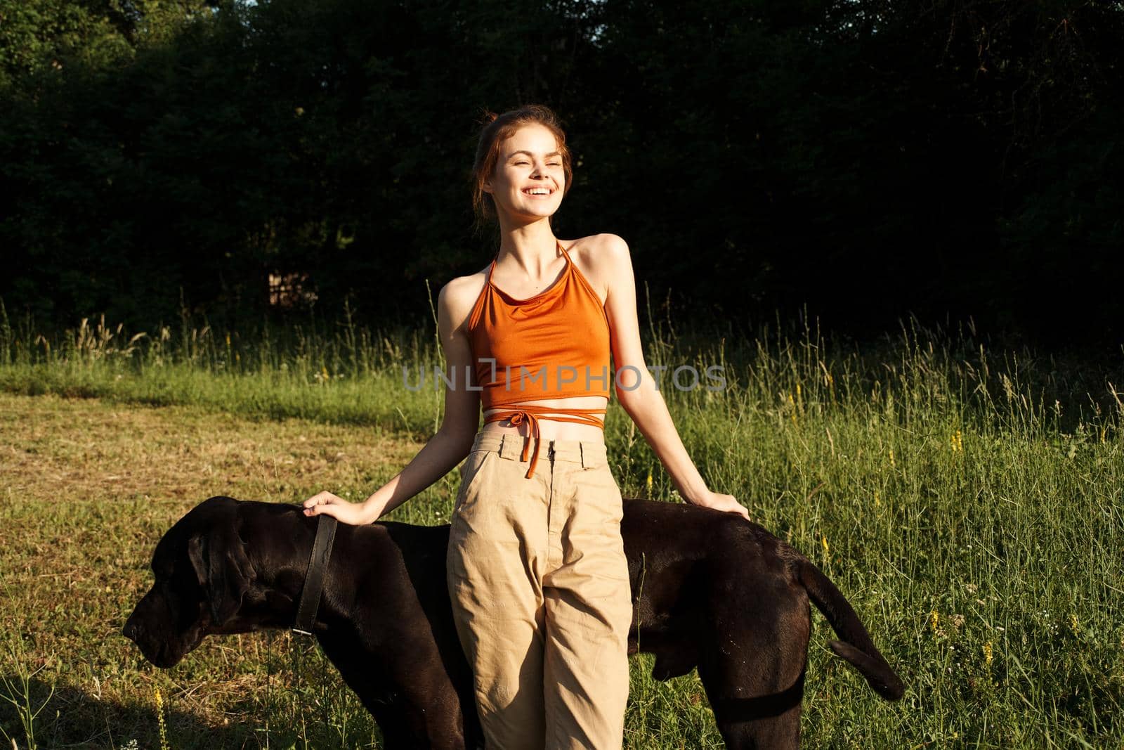 cheerful woman outdoors with dog and fun nature by Vichizh