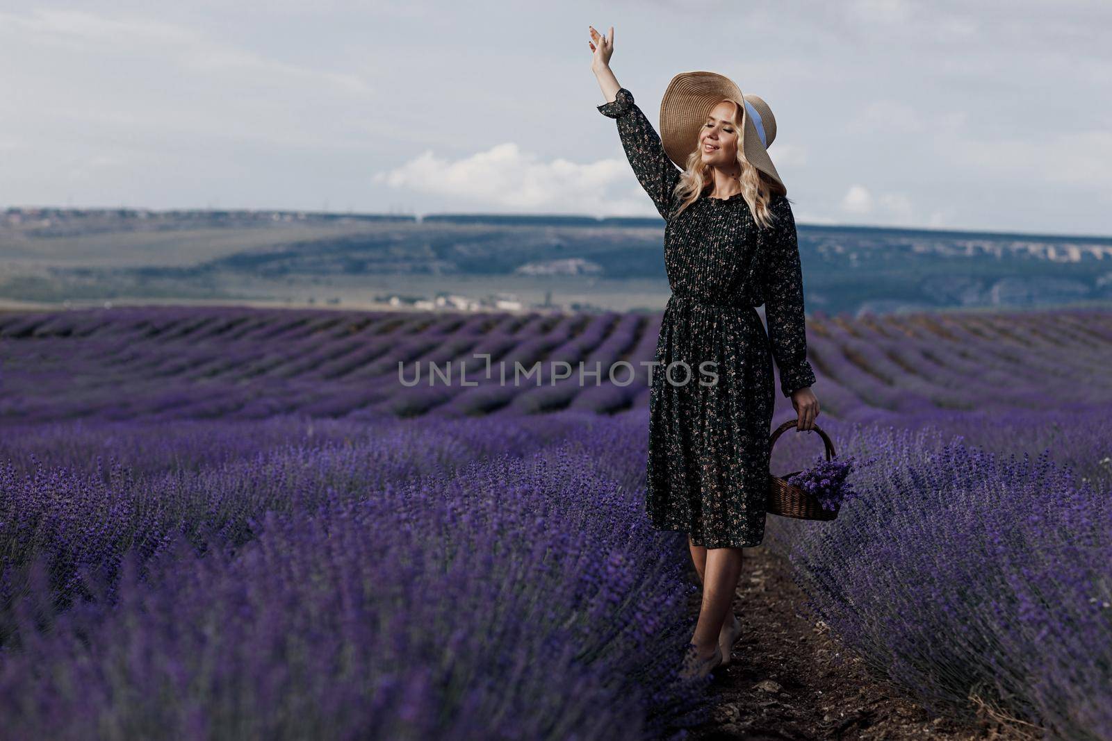 Fashion portrait of a pretty young woman in lavender field. High quality photo