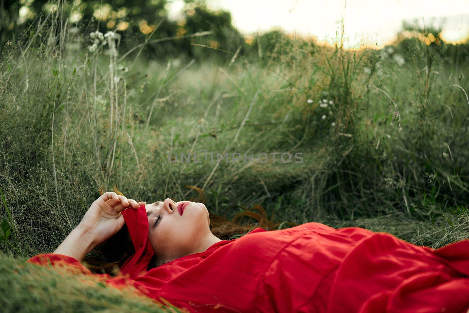 woman in red dress lying on the grass fresh air nature romance by Vichizh