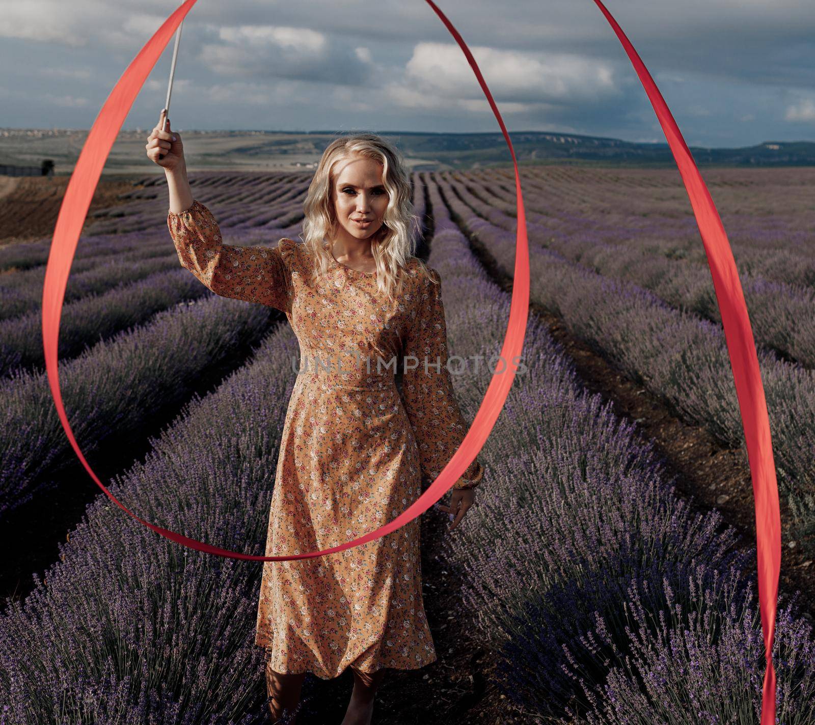 Fashion portrait of a pretty young woman in lavender field. High quality photo