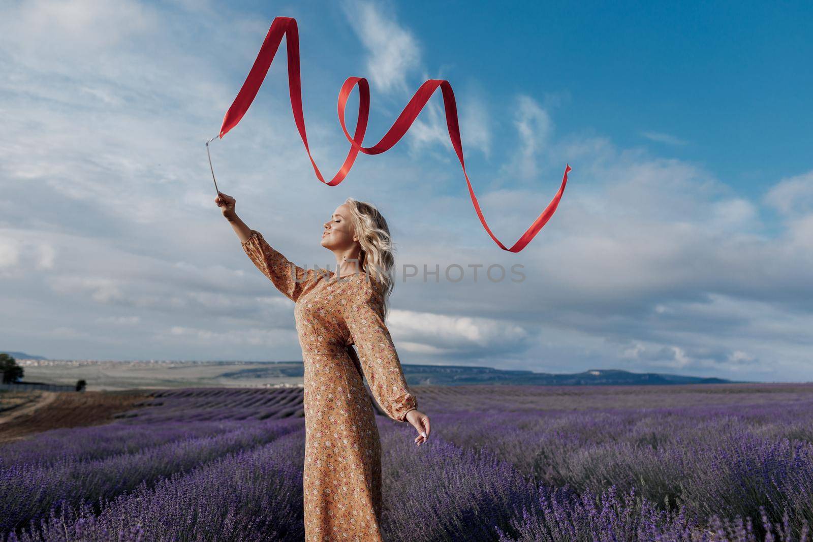 Fashion portrait of a pretty young woman in lavender field. High quality photo