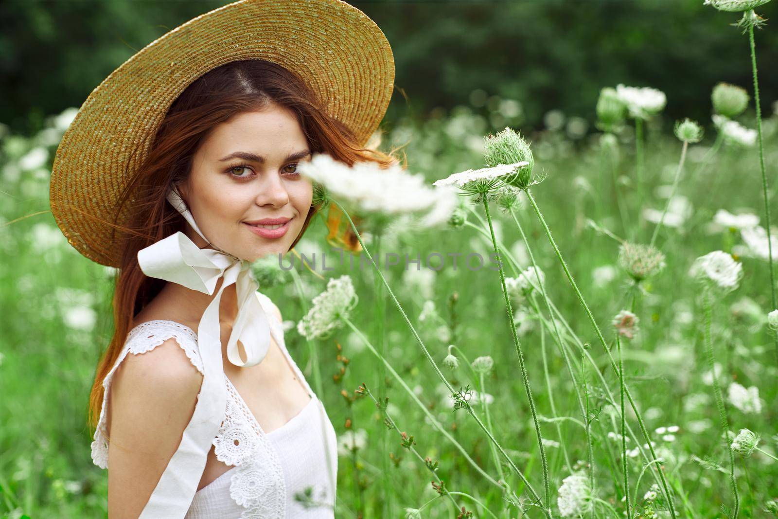 Woman with hat white dress flowers nature relaxation. High quality photo