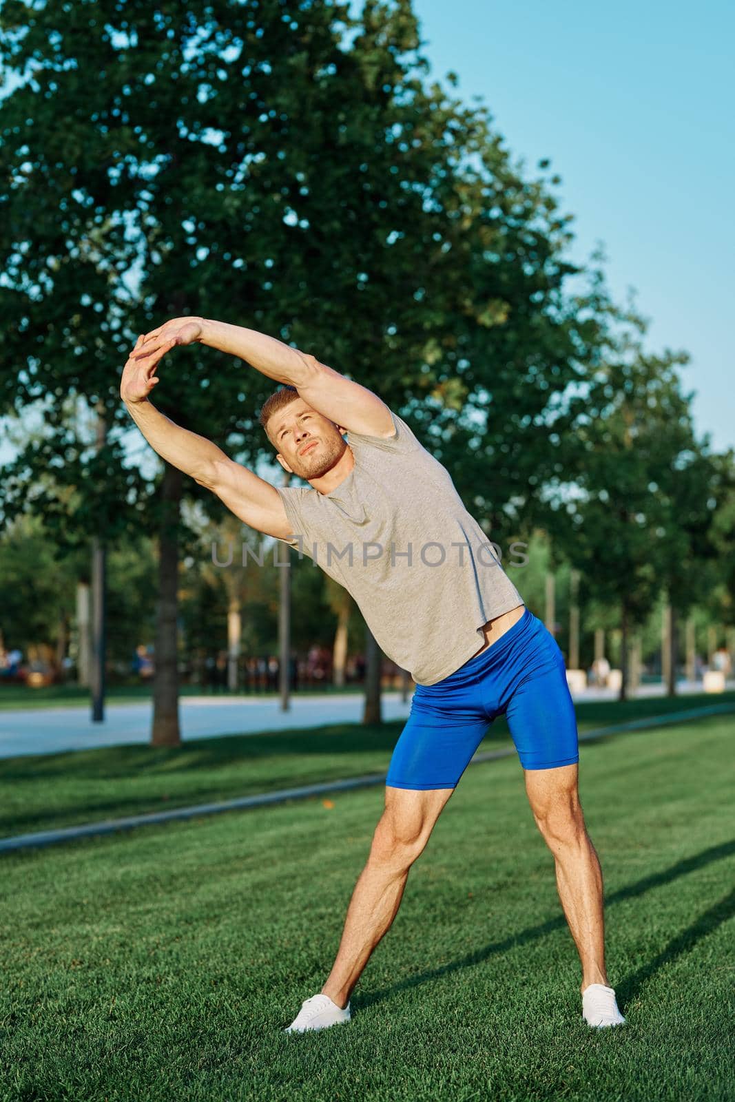 athletic man in the park workout jogging exercise summer. High quality photo