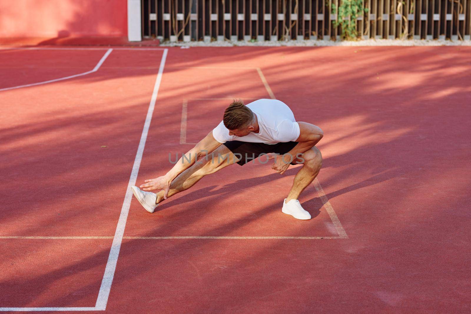 man on the sports ground exercise warm-up lifestyle. High quality photo