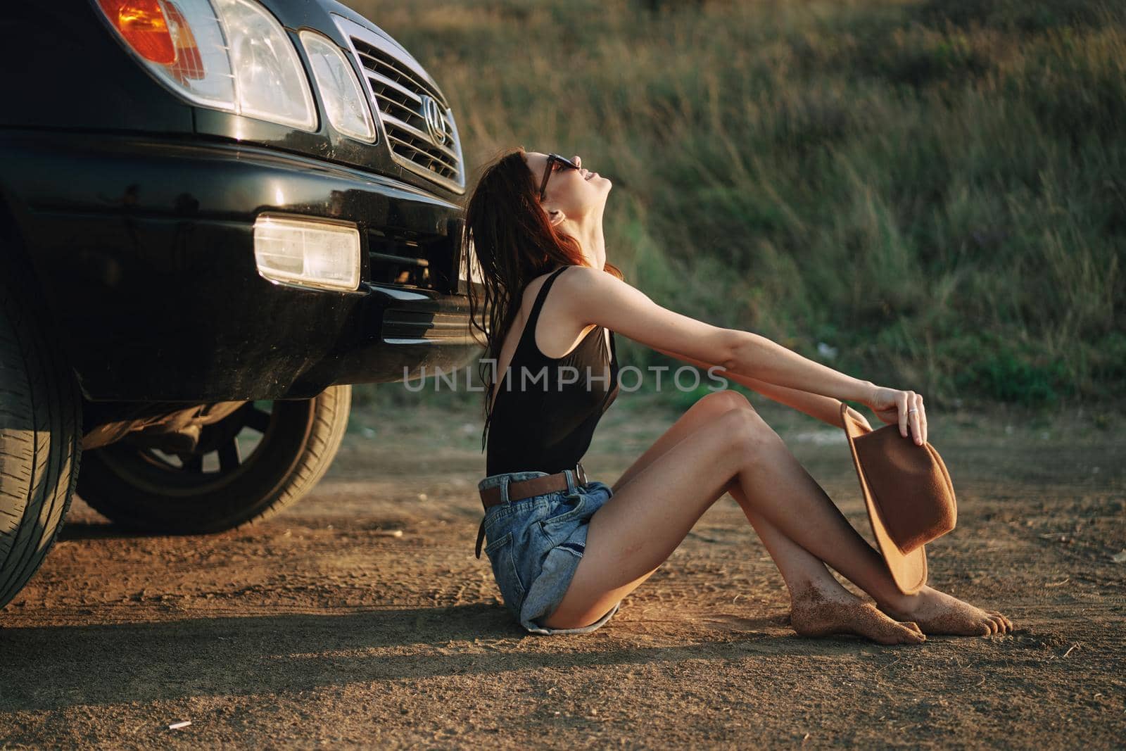 woman in sunglasses near car travel summer vacation landscape. High quality photo