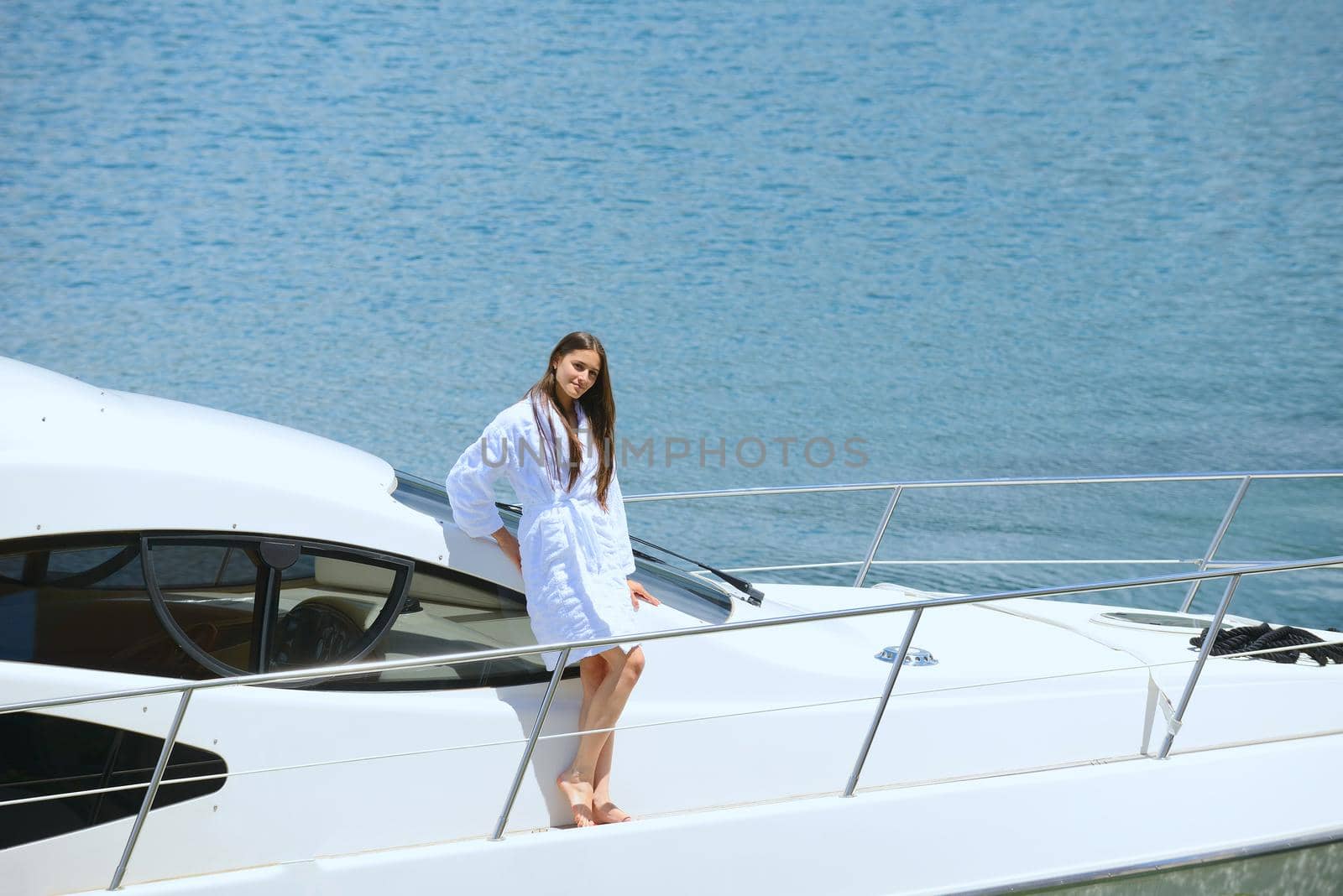 woman lies on a luxury yacht in the sea and looking to the horizon