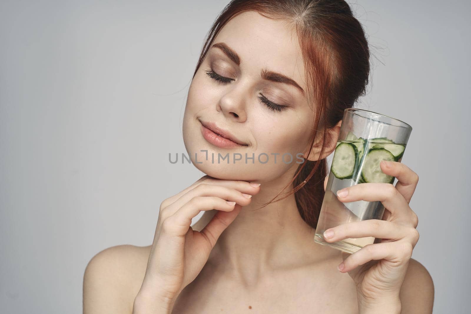 woman with bare shoulders cucumber health drink Fresh. High quality photo