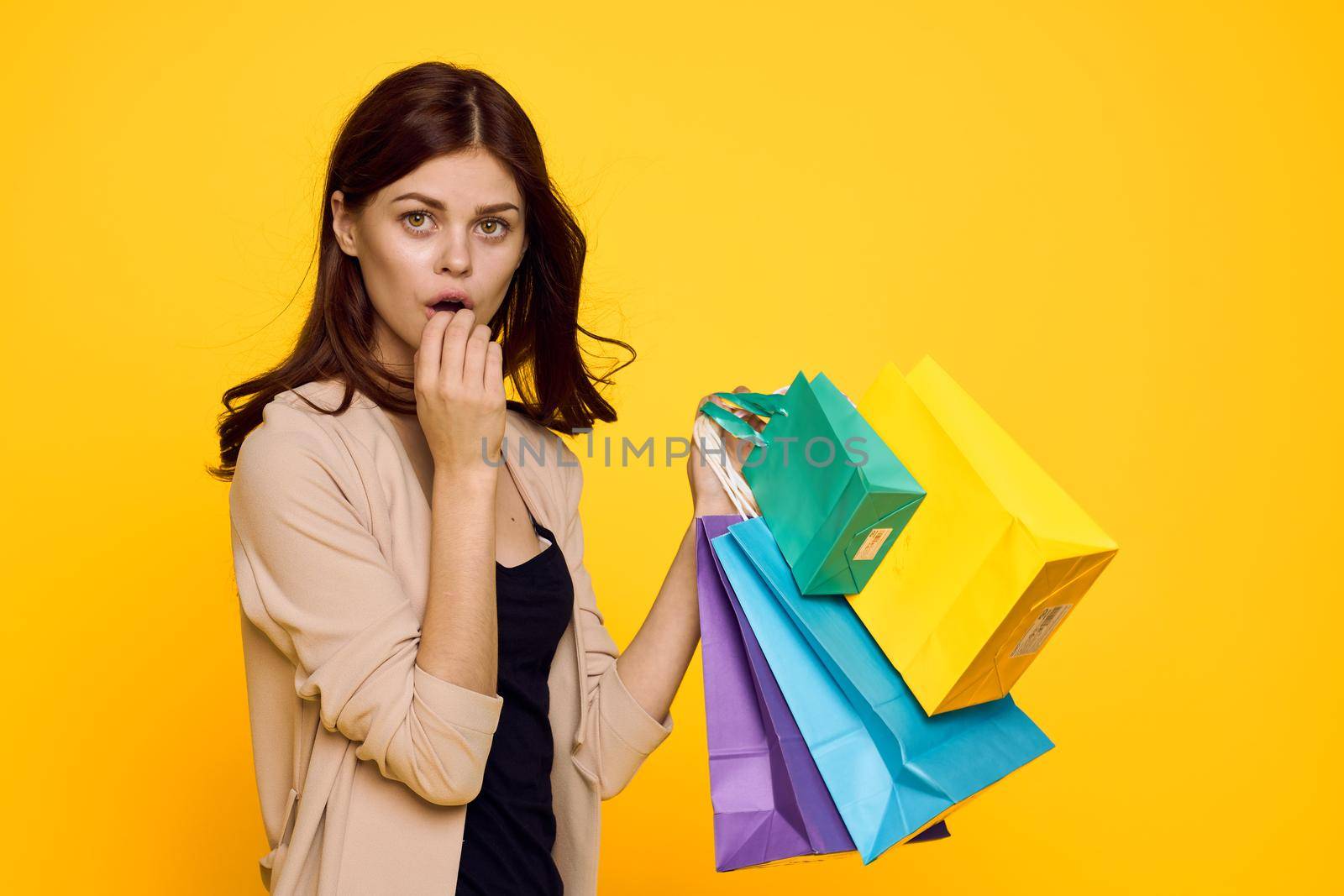 cheerful woman shopping entertainment lifestyle yellow background. High quality photo