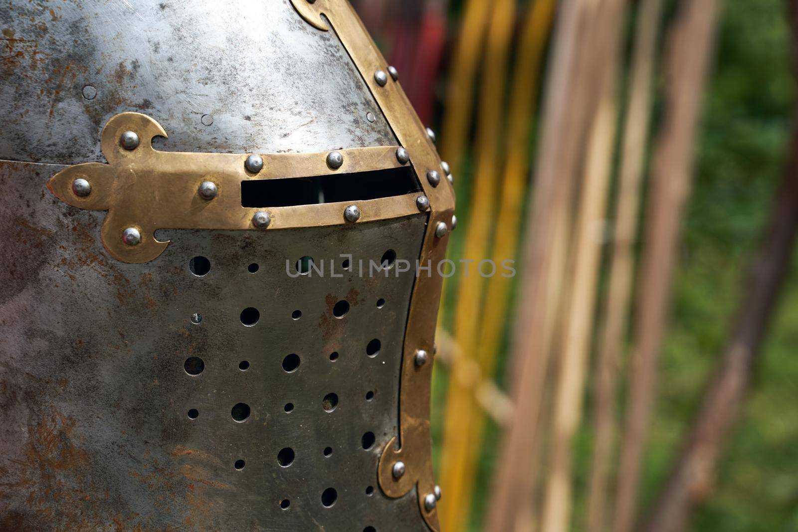 Knight metal helmet on spears background