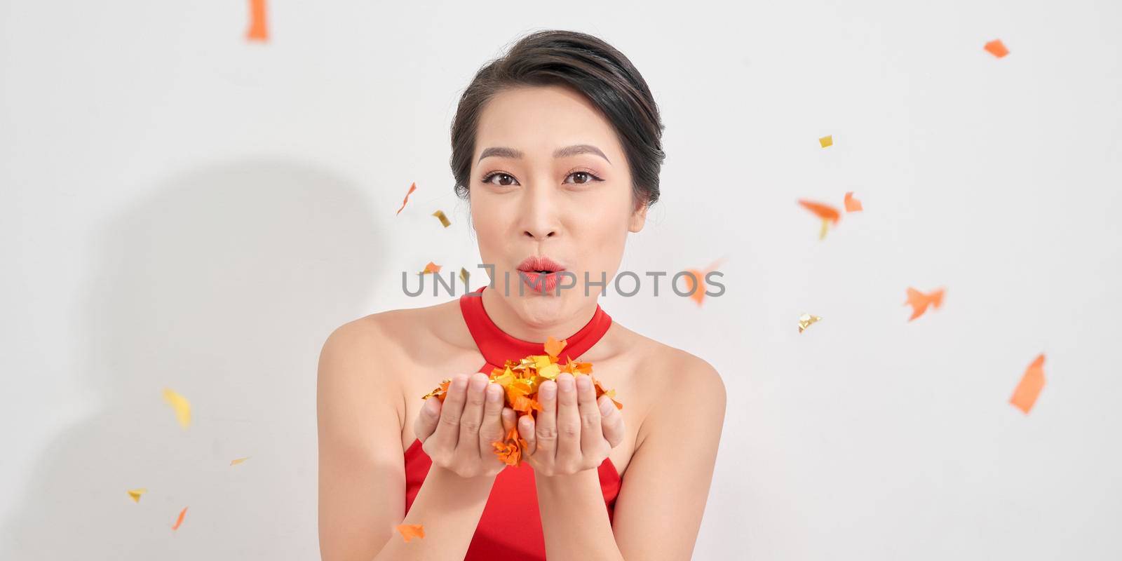 Photo of amazing lady blowing shiny confetti making fairy tale wear red dress isolated white background by makidotvn