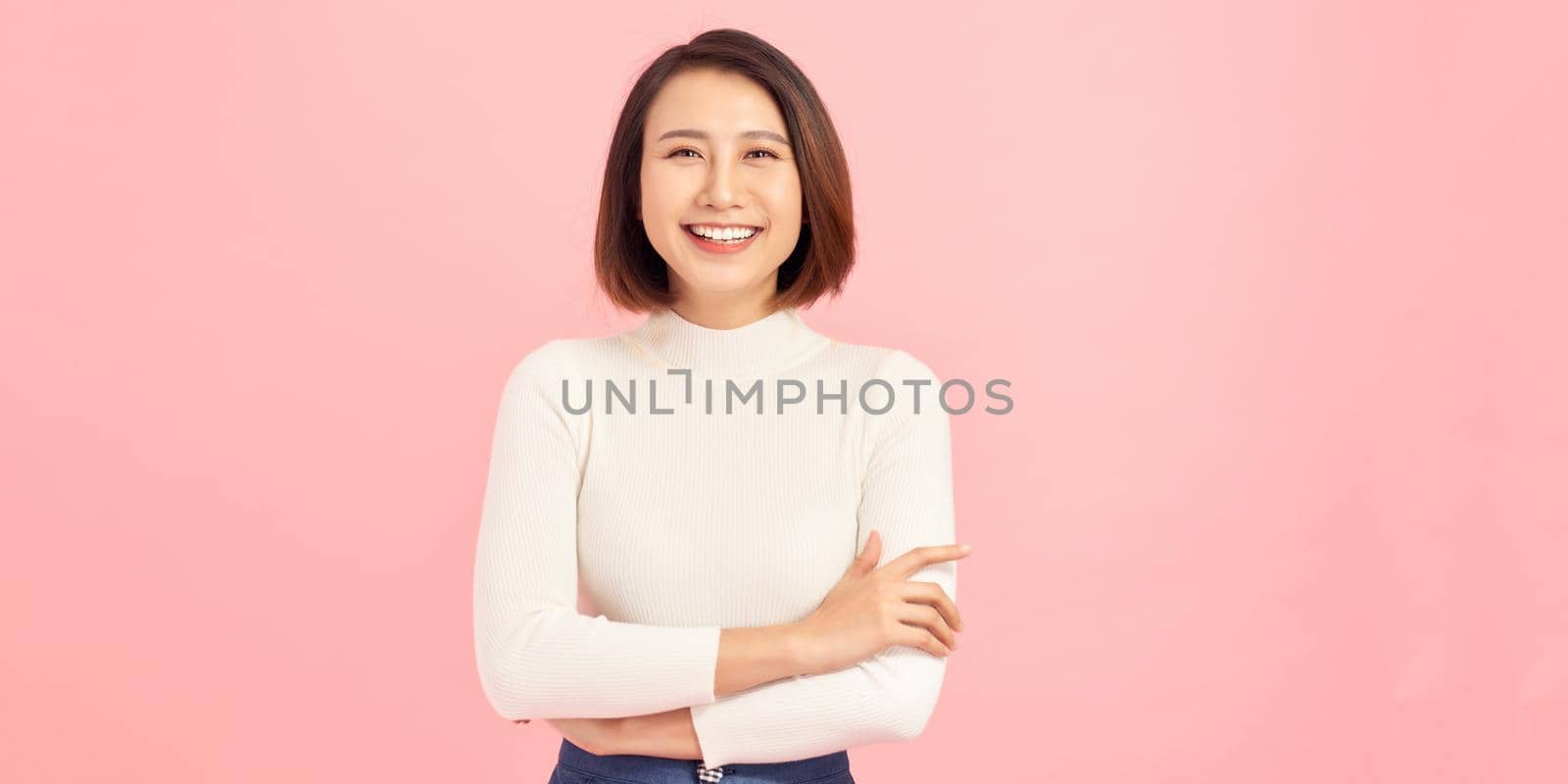 Attractive charming business lady smiling hold arms hands crossed good mood self-confident successful worker person wear white t-shirt isolated pink color background by makidotvn